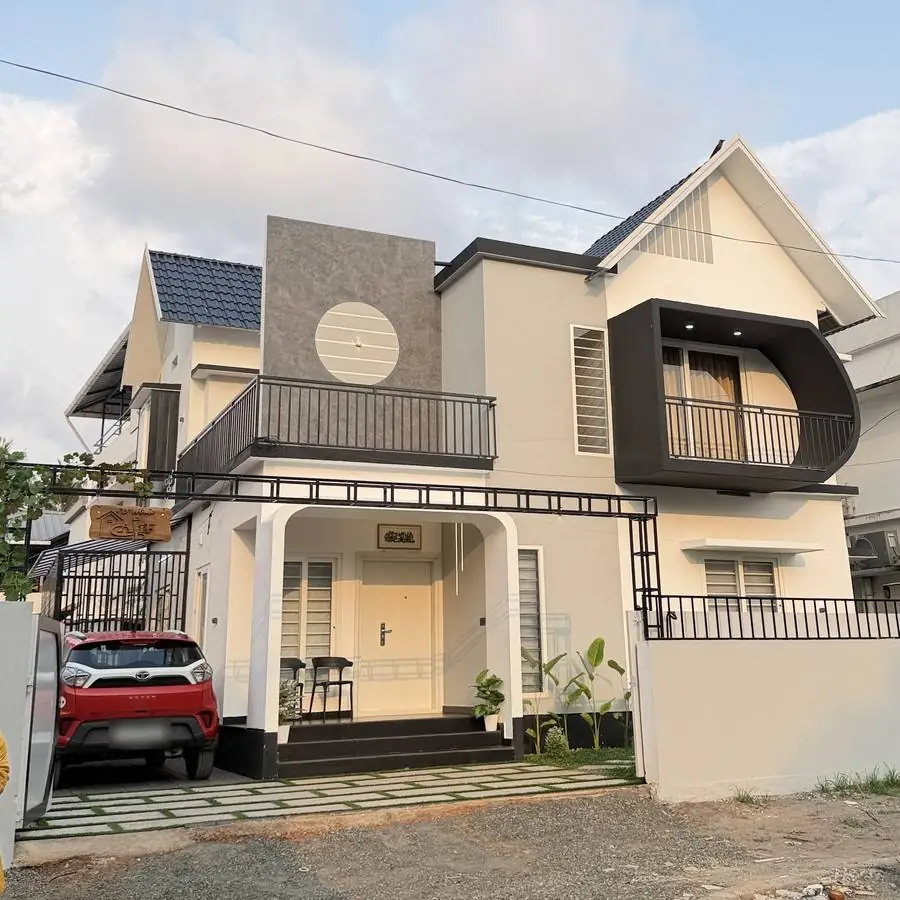 Two-storey grey and white residence with a curved black balcony box
