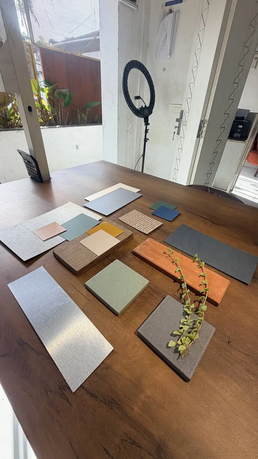 Tile, laminate and metal samples laid out on a studio table
